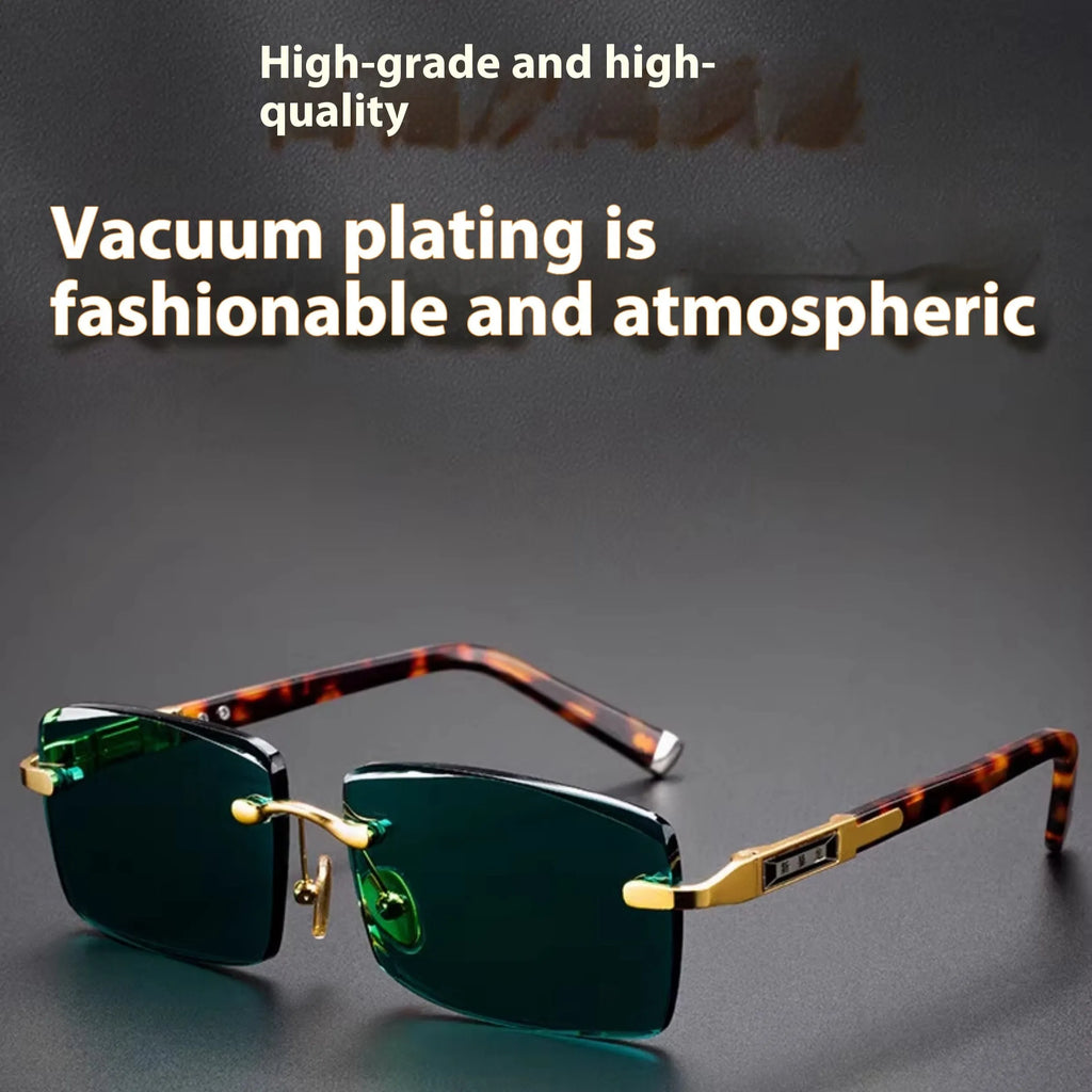 Frameless dark green crystal lens sunglasses with adjustable nose pads on a table next to their hard case.