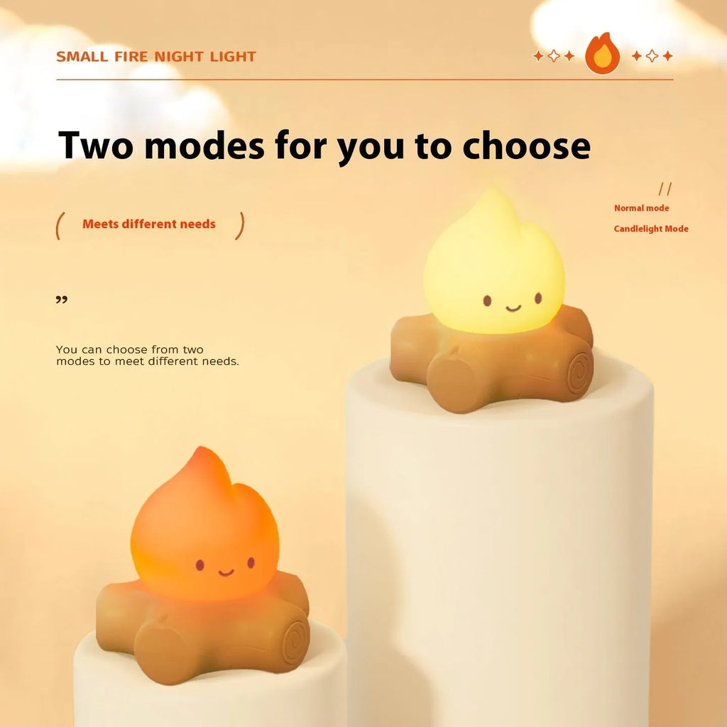 Silicone small fire pile cartoon night lamp with ABS shade on a surface.