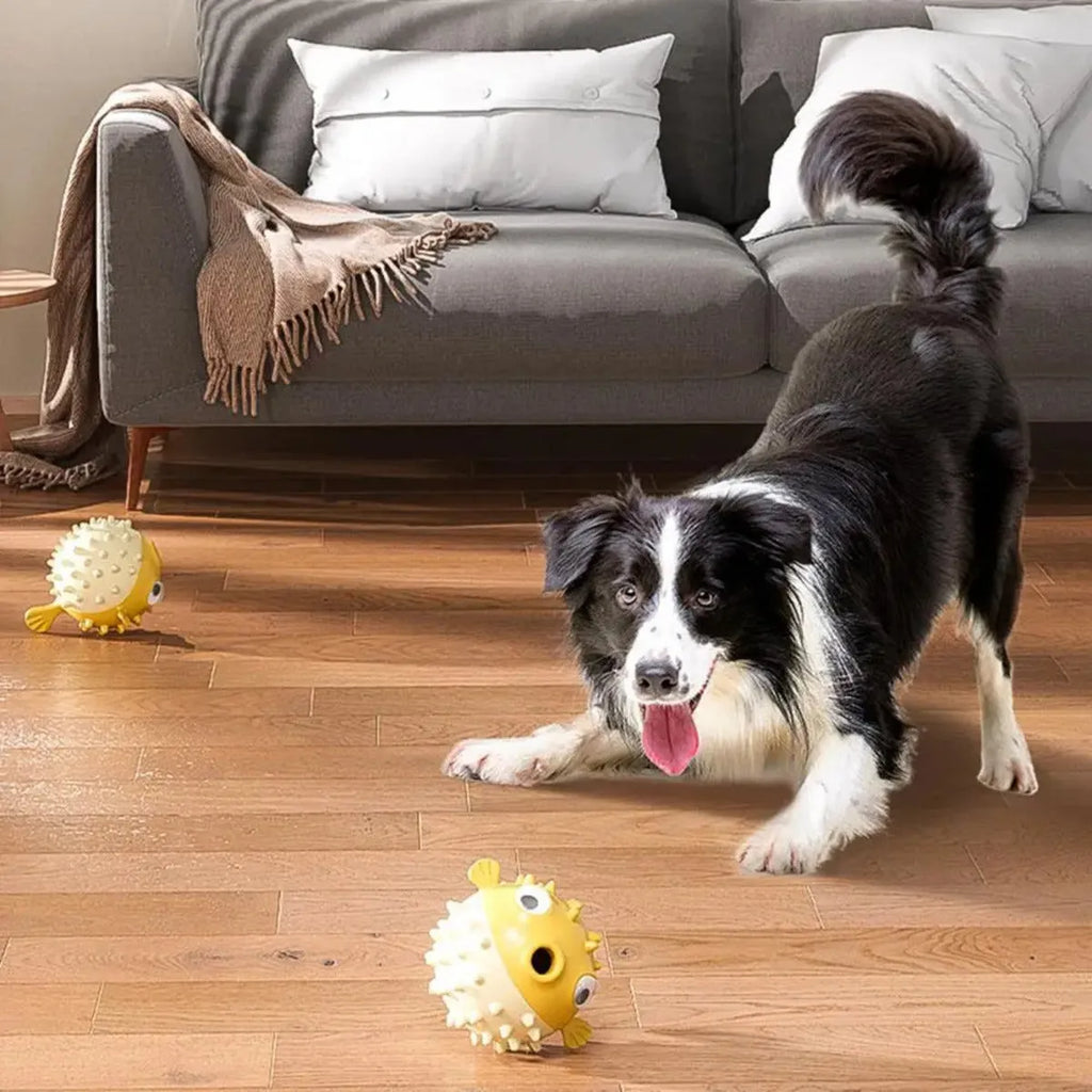 Yellow vinyl fish-shaped dog chew toy with textured surface and squeaker inside.