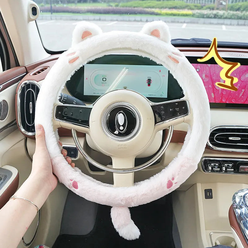 Plush furry steering wheel cover with embroidered panda face, fitted on a car steering wheel.