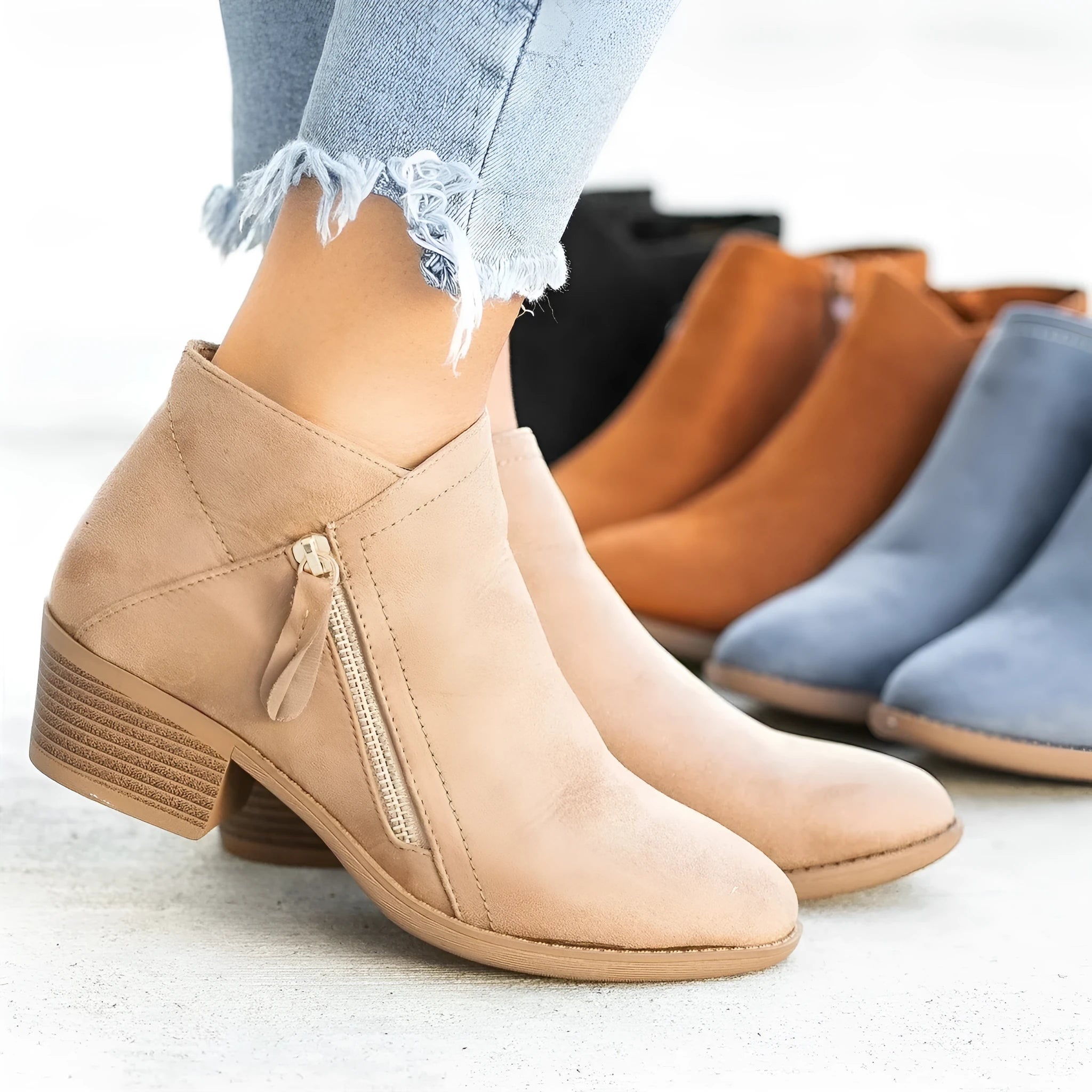 Women's blue suede ankle boots with a chunky heel and a side zip fastener
