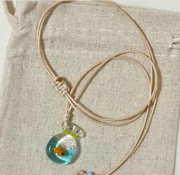 Women's joker pendant necklace on braided cotton linen cord with adjustable lobster clasp.