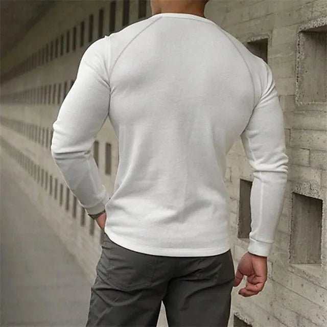 Men's white long-sleeved t-shirt with a Henry collar laying flat.