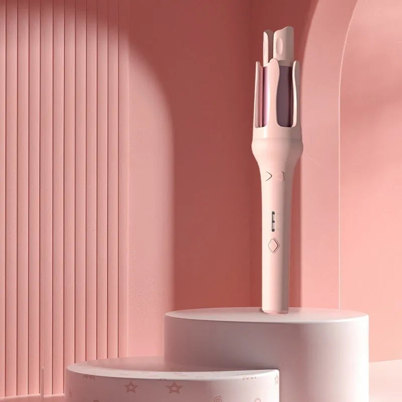 White and pink automatic hair curler with a 32mm ceramic barrel and a US plug adapter on a table.