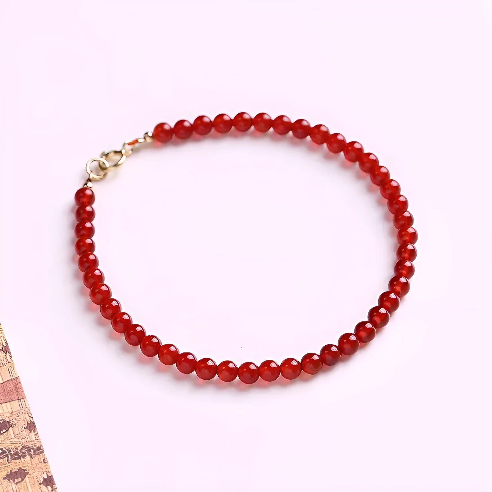Ultra-thin red agate bracelet for women on a white background.