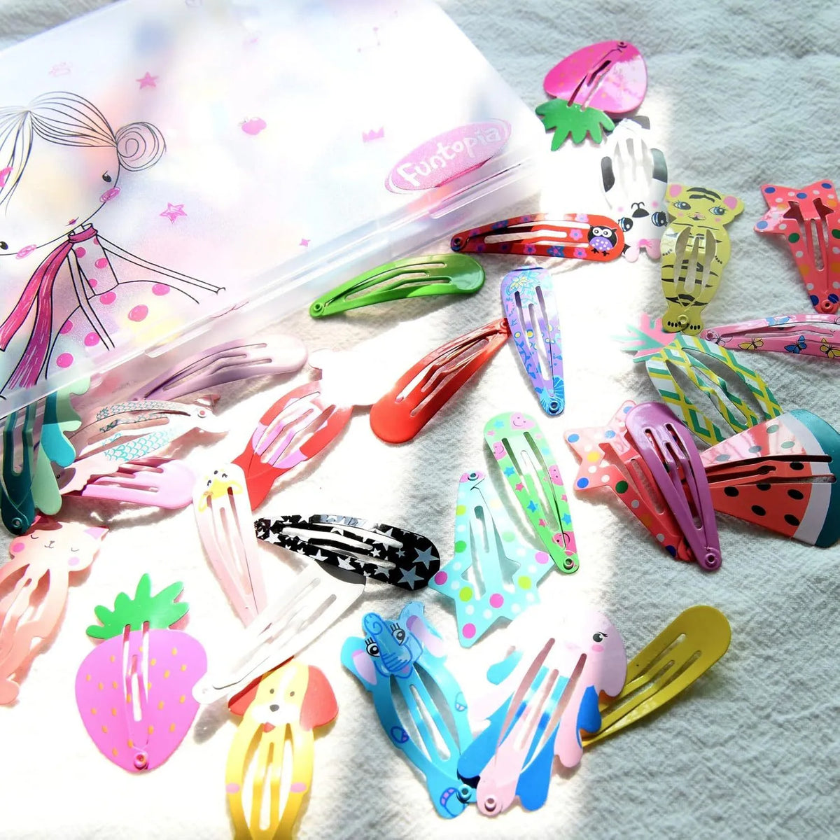Assorted candy colour metal snap hair clips with animal, fruit, crown, star, and flower designs.
