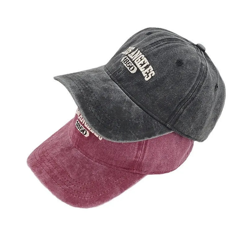 Retro-style personalised embroidered peaked cap with adjustable strap on distressed beige fabric.