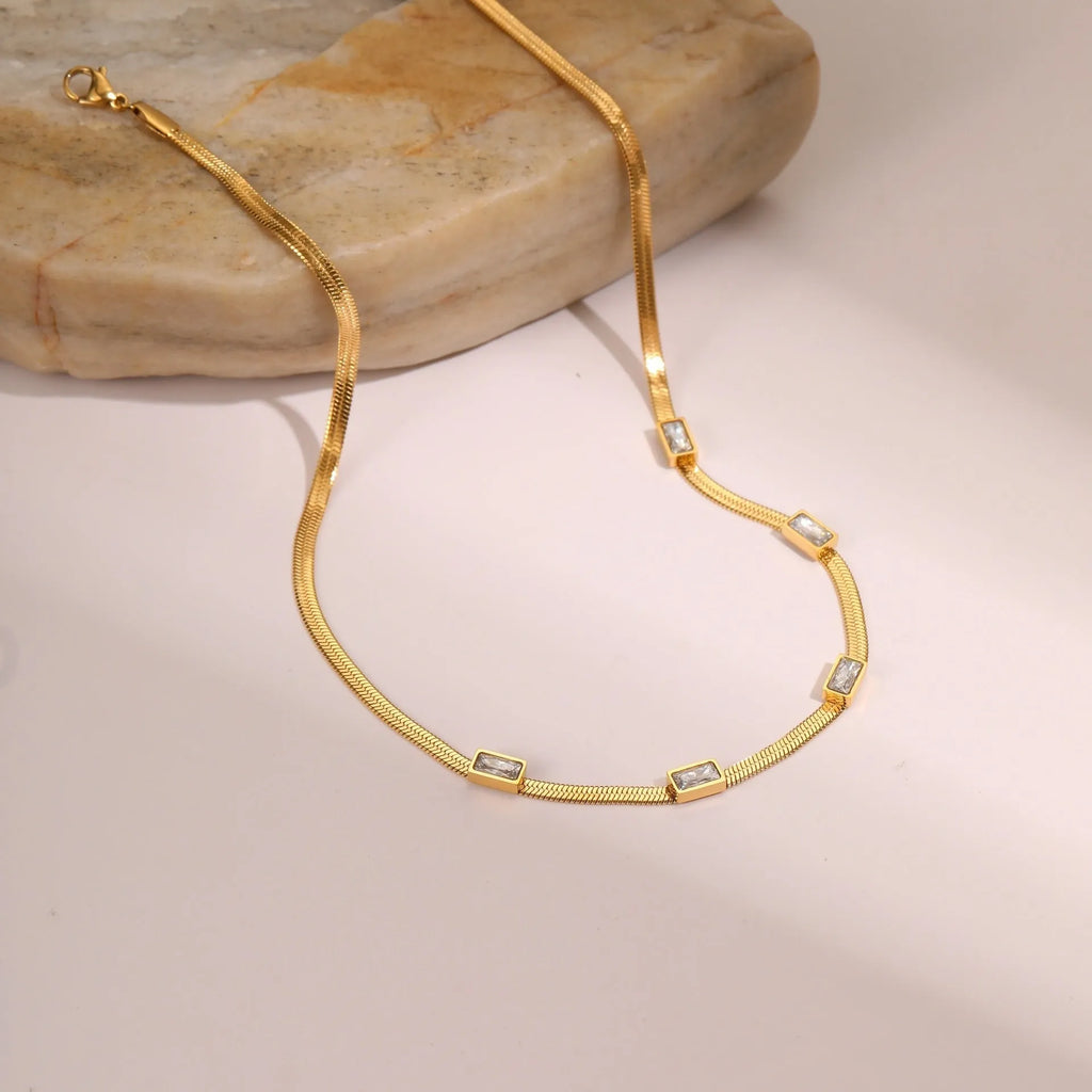 Geometric square zircon pendant on a flat stainless steel snake chain necklace in gold or steel colour.