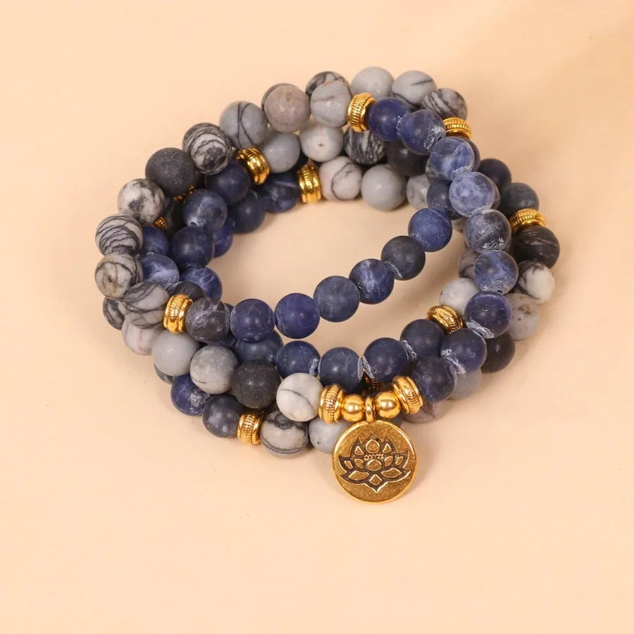 Multi-layer blue bracelet with patterned network stone beads on an alloy chain, natural style.