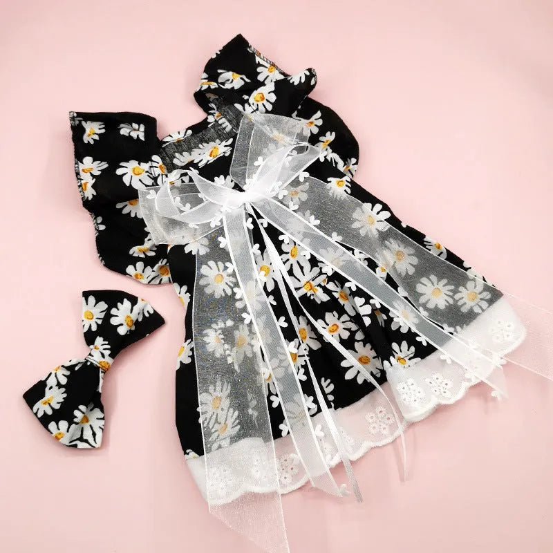 Breathable lace and plaid gauze dog skirt in Pink Daisy with matching bow necklace on a small dog