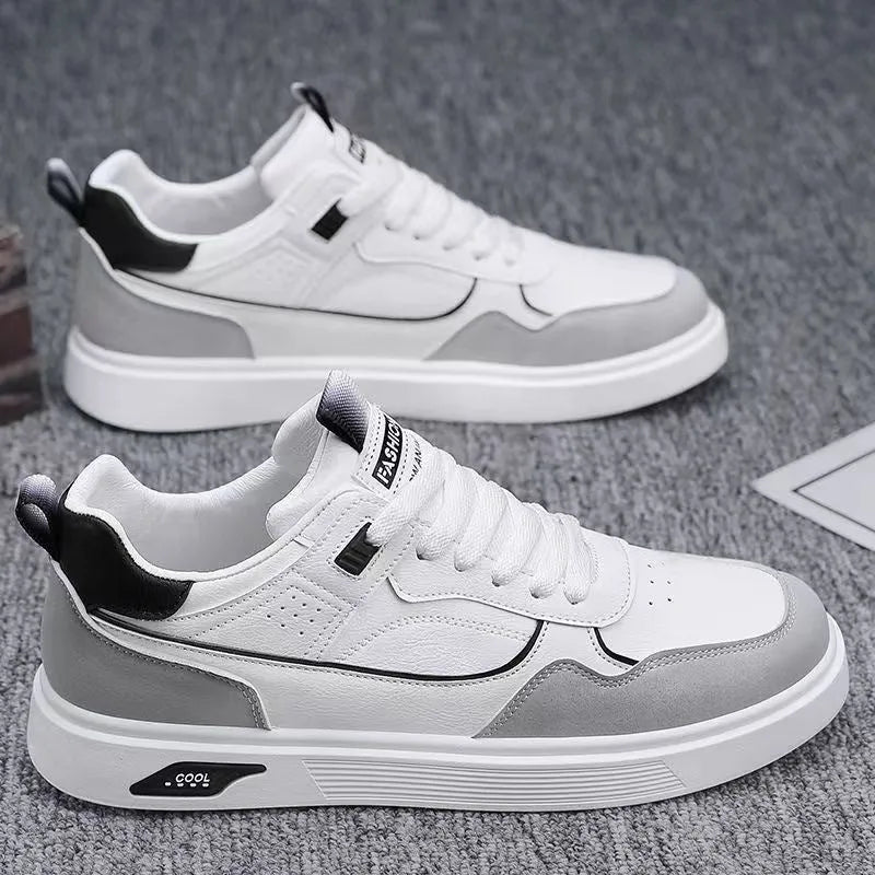 Men's beige low-top canvas board shoes with leather stitching details on a white background.
