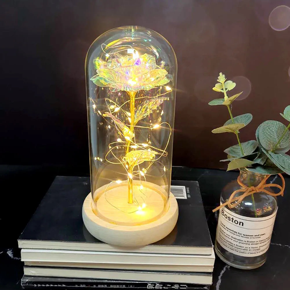 LED rose bouquet with glass lampshade showing warm white lights on simulation silk flowers.