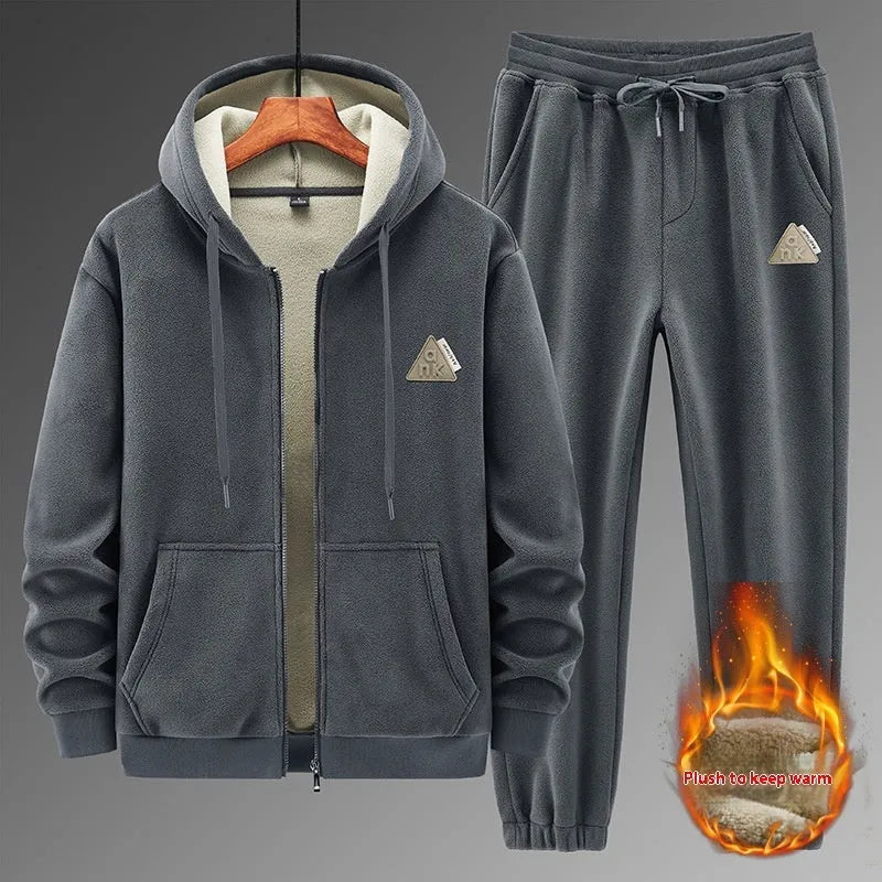 Man wearing a grey hooded sweater and matching casual trousers from a two-piece set.