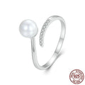 Sterling silver adjustable ring with shell pearl centrepiece on grey background