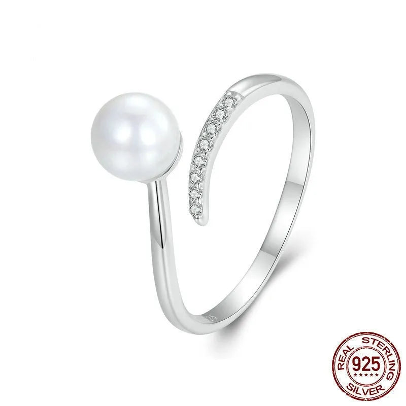 Sterling silver adjustable ring with shell pearl centrepiece on grey background