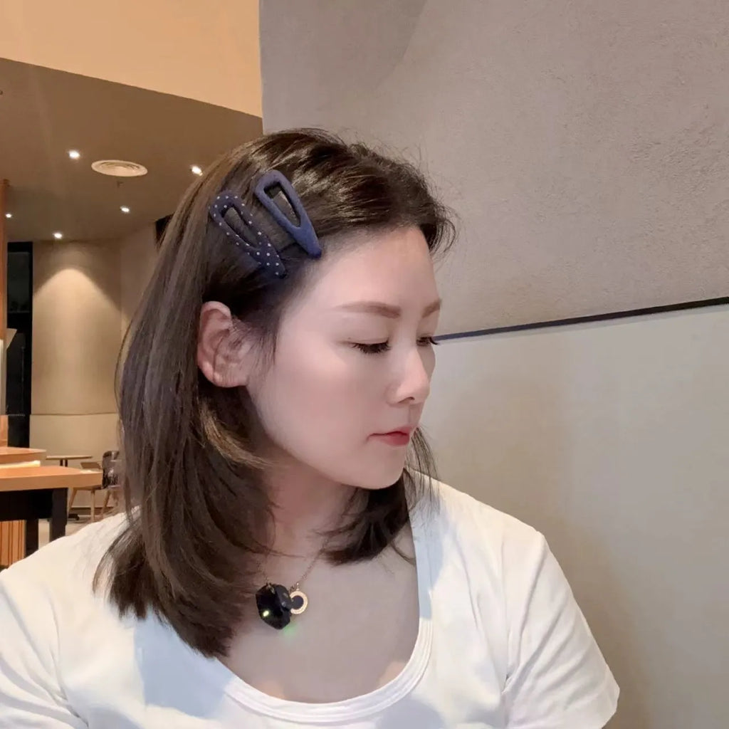 Retro style hair barrettes in dark denim and polka dot patterns, showing triangle and water drop shapes.