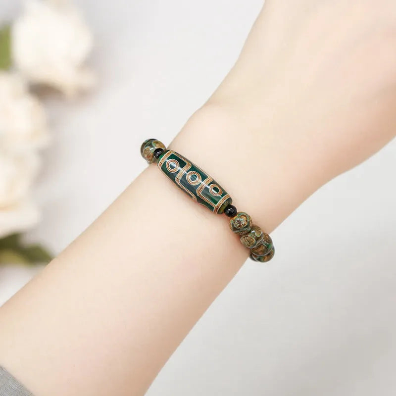 Handmade dzi bead bracelet with 8mm barrel beads in green, unisex geometric design.