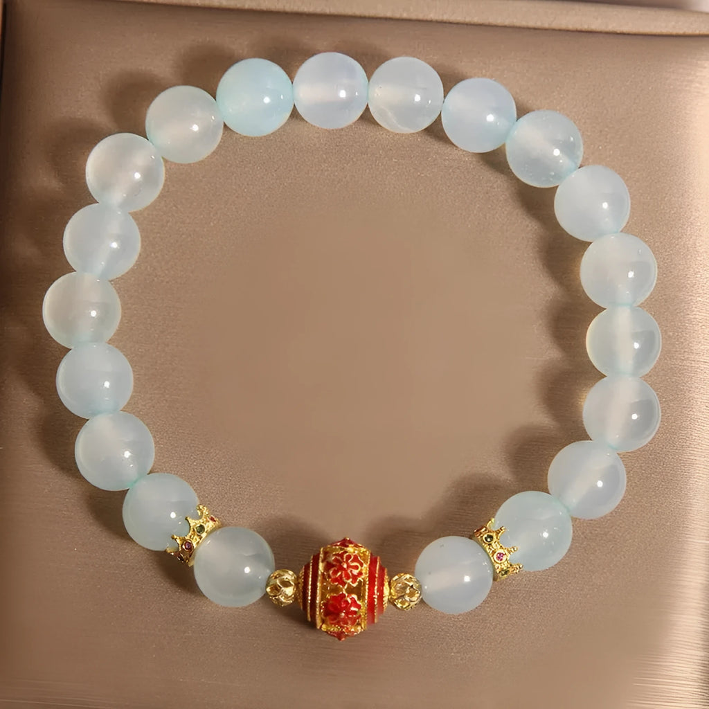 Women's blue agate and crystal bracelet with colourful lucky beads on a wrist.