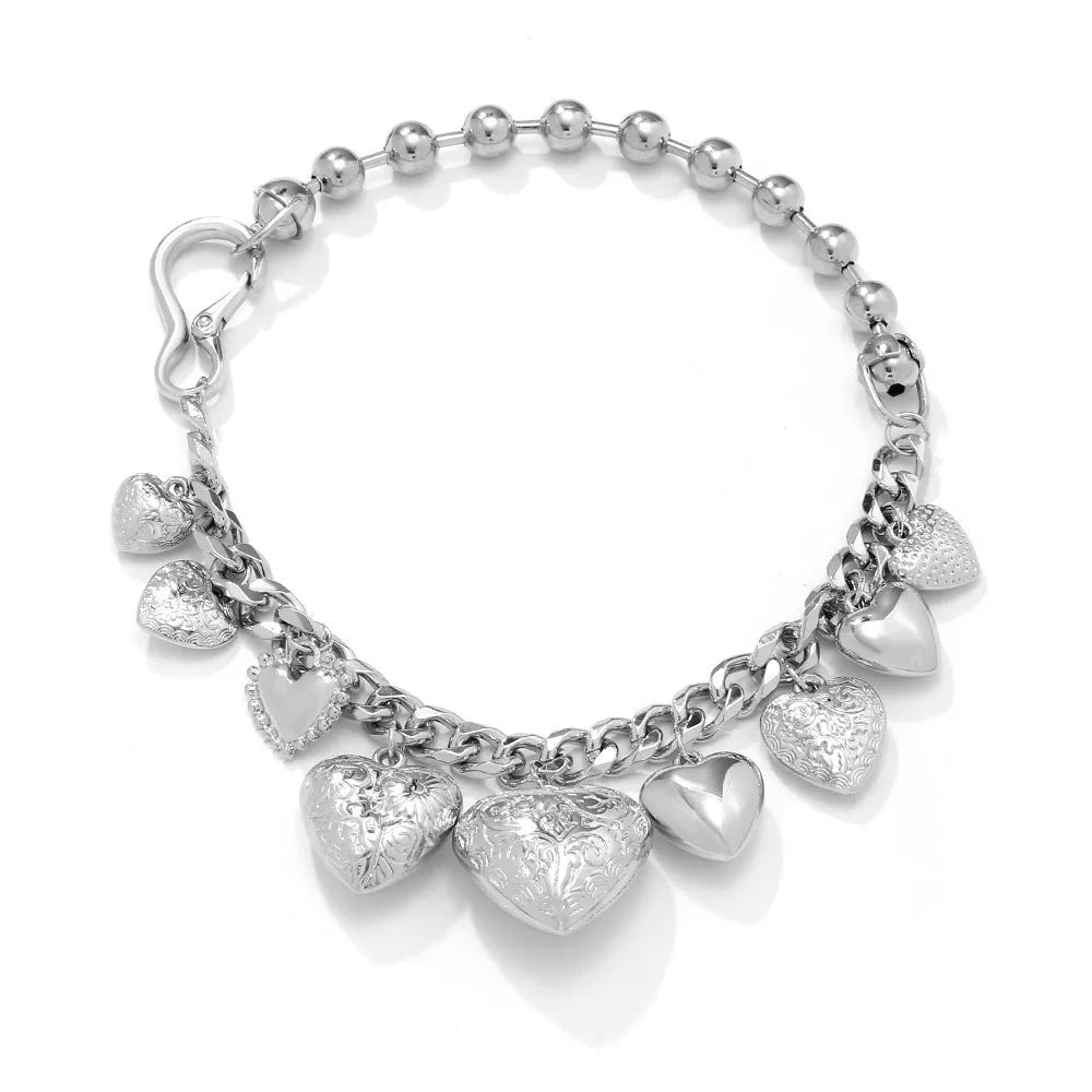 Gold carved heart-shaped pendant necklace on an adjustable metal chain.