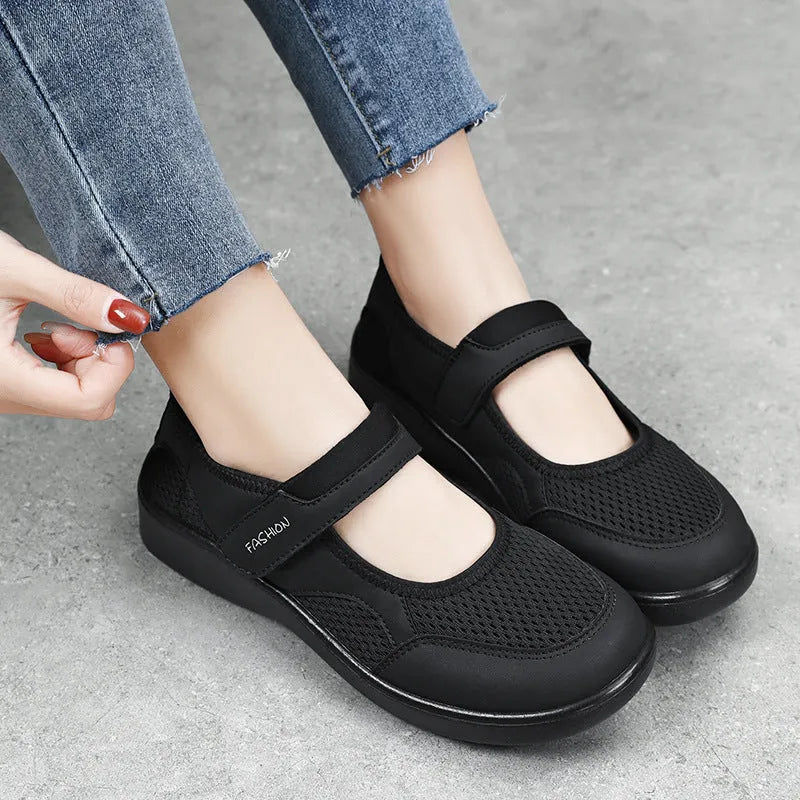 Women's low-top grey mesh casual trainers with Velcro fastening and a flat polyurethane sole.