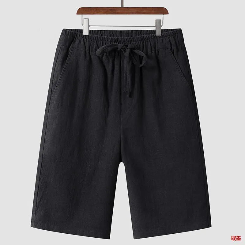 Man wearing beige linen loose-fit cropped shorts on a summer day.
