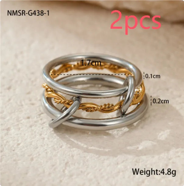 Stacked gold plated stainless steel rings with an exaggerated wide band design, shown in a free size.
