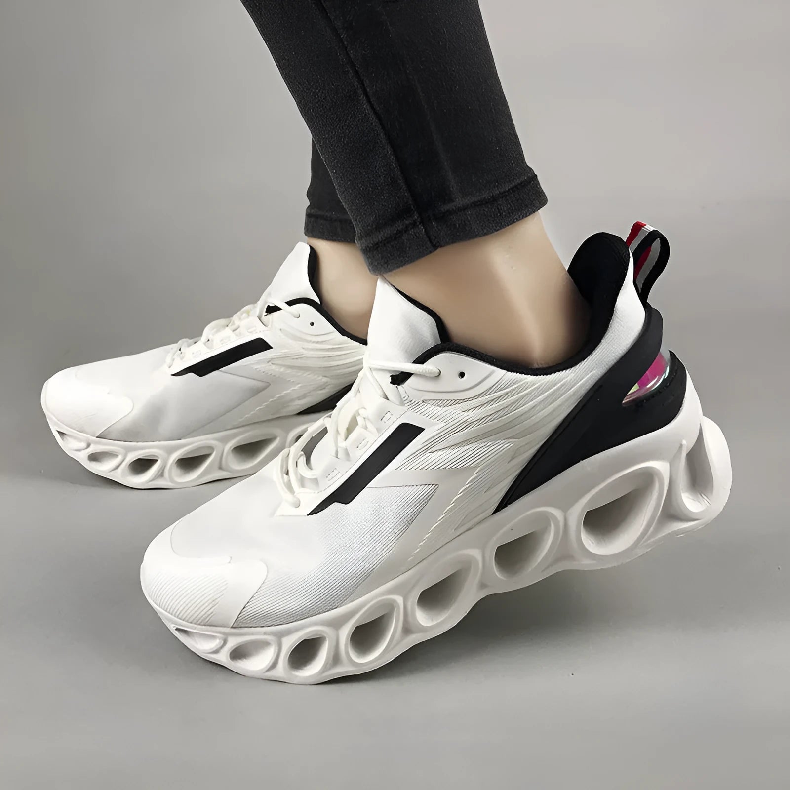 Breathable low-top lace-up casual trainers in black, white, and dark blue colours on a white background.