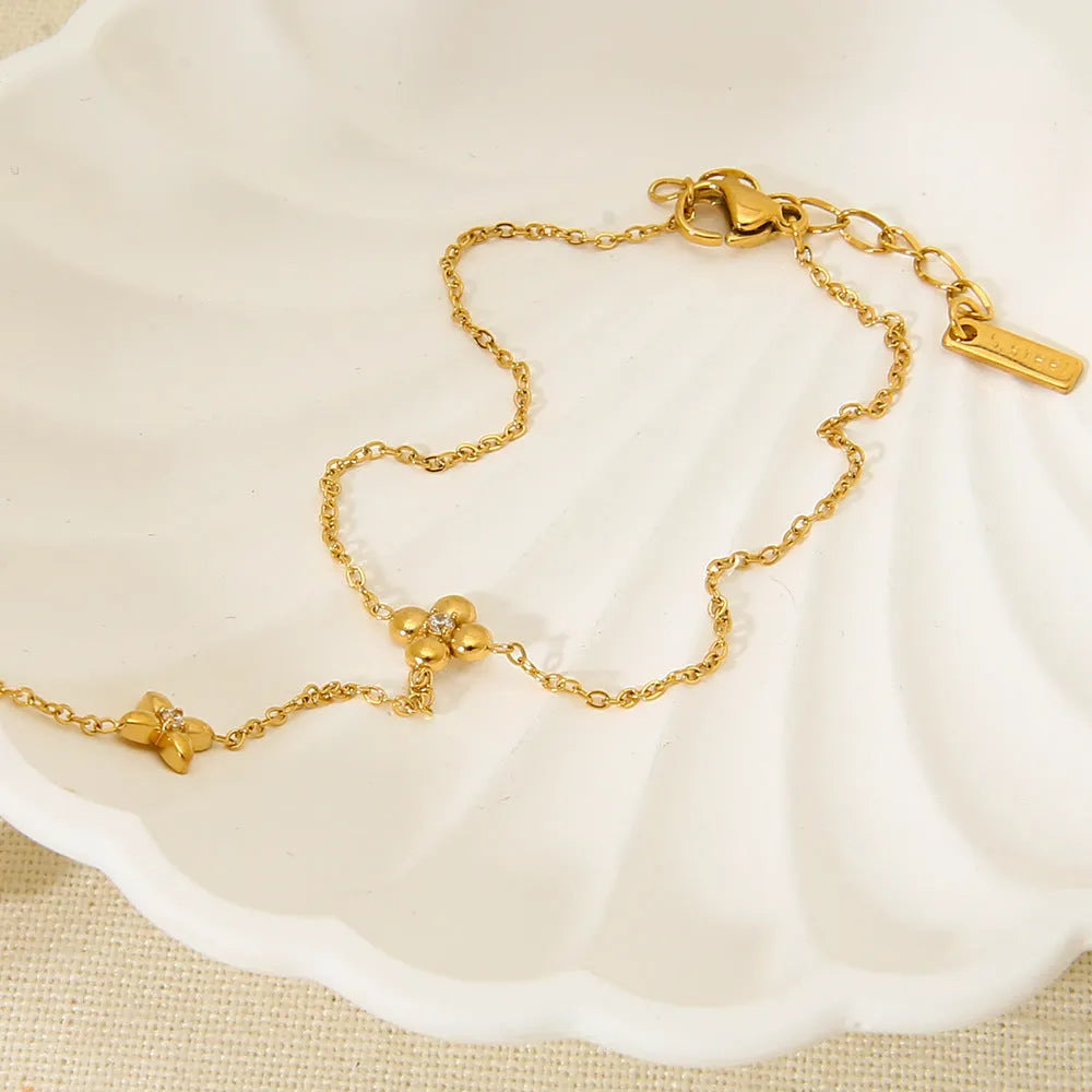 Women's stainless steel bracelet with geometric flower and eight-pointed star charms in gold colour