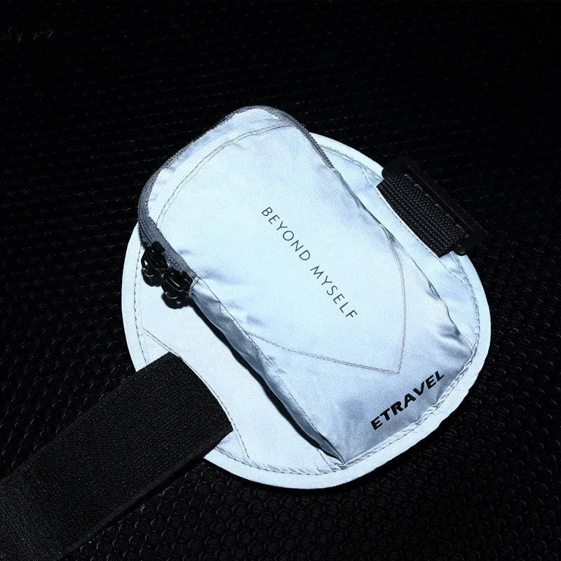 Reflective black running arm bag with adjustable strap, holding a mobile phone, shown on a runner's arm.