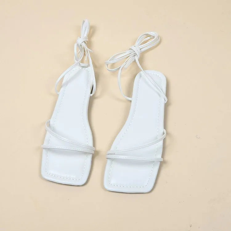 Women's ankle ring bandage cloth flat sandals in white, with front lace-up and square toe on a rubber sole.