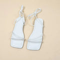 Women's ankle ring bandage cloth flat sandals in white, with front lace-up and square toe on a rubber sole.