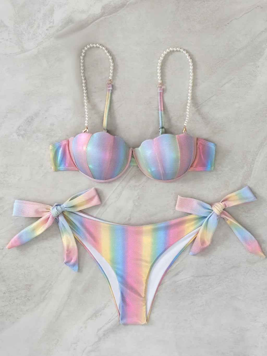 Women's rainbow colour adjustable tied bikini swimsuit on a hanger.