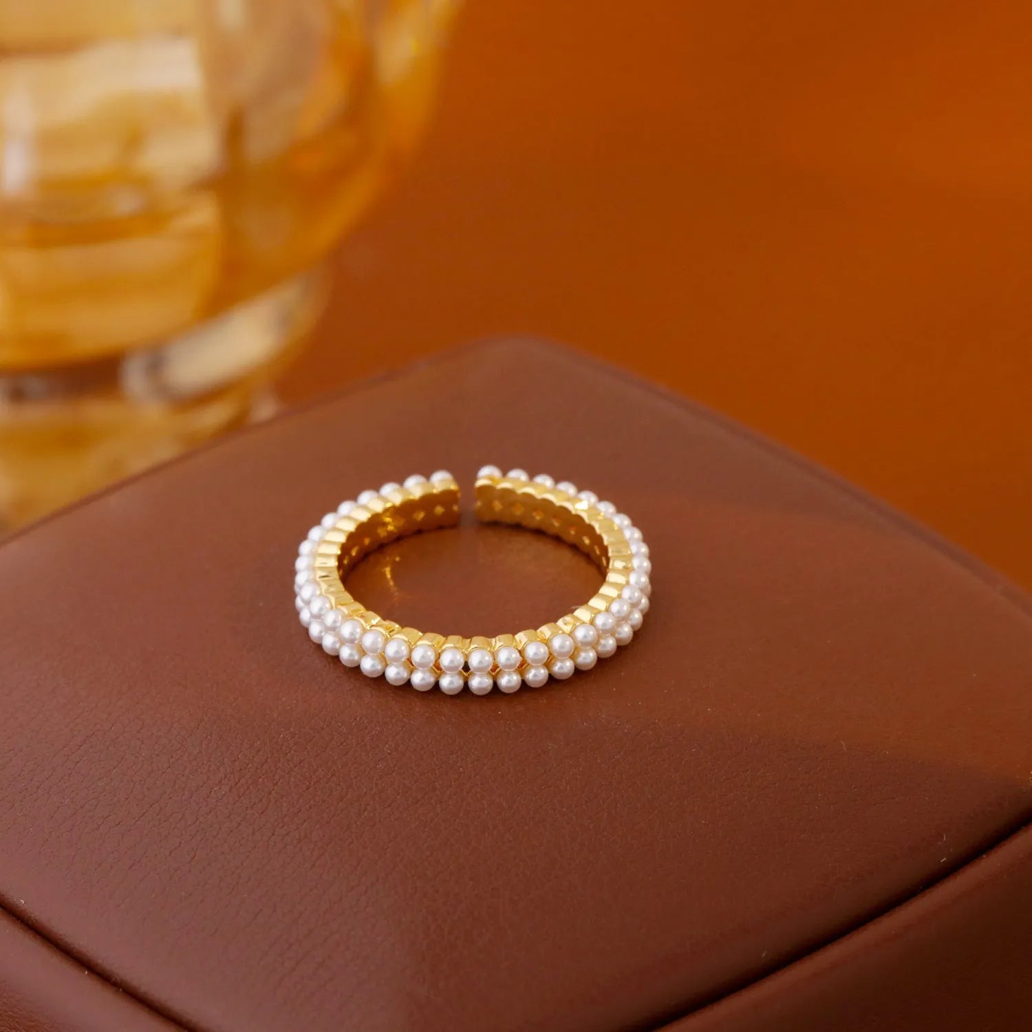 Gold geometric women's ring with open mouth adjustable design and single pearl accent on copper base