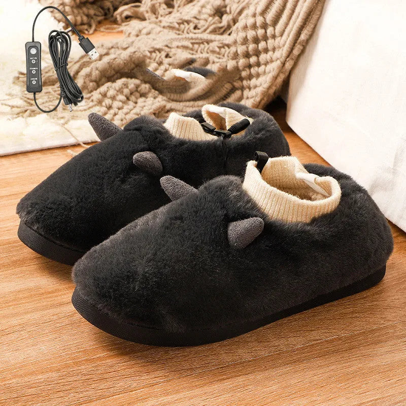 USB electric foot warmer slippers in grey with a connected USB cable on a wooden floor.