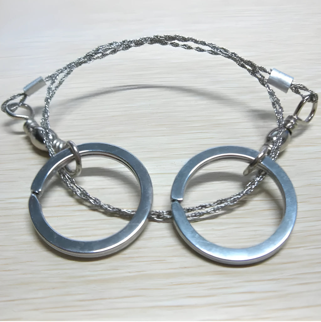 Stainless steel survival wire saw with ring attachments showing 55cm cutting length