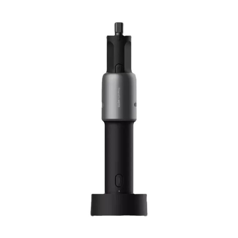 Black hand held rechargeable grinder with USB cable and accessory kit on workbench