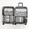 Set of 7 waterproof nylon travel tote bags in black, gray, dark blue, blue, and orange showing different sizes