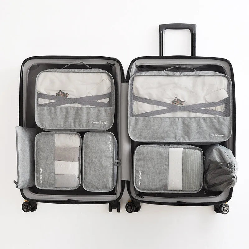 Set of 7 waterproof nylon travel tote bags in black, gray, dark blue, blue, and orange showing different sizes