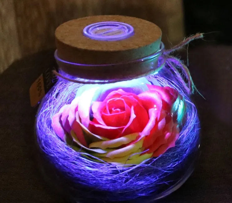 Colorful rose soap flower in glass wishing bottle with four colour options for decor or gift