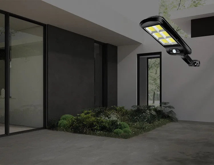 Black solar-powered outdoor motion sensor light with solar panel