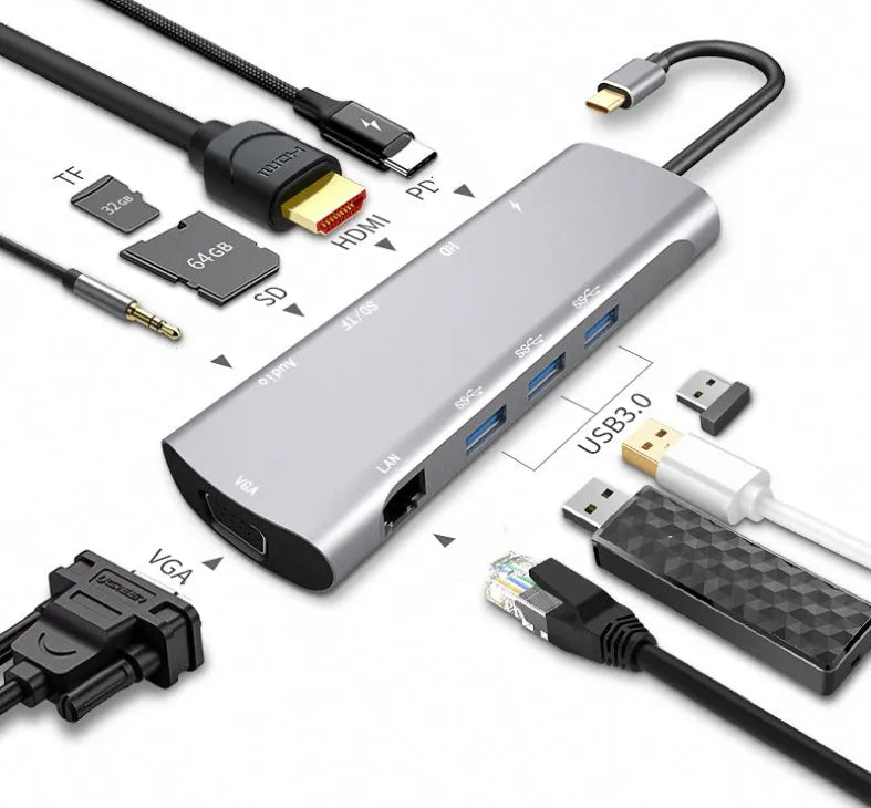 Grey aluminium USBC docking station with HDMI, VGA, USB ports and a short attached cable on a wooden desk