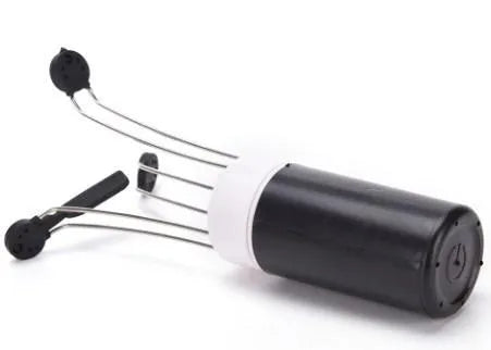 White and black wireless automatic blender with stainless steel stirring arms on kitchen counter