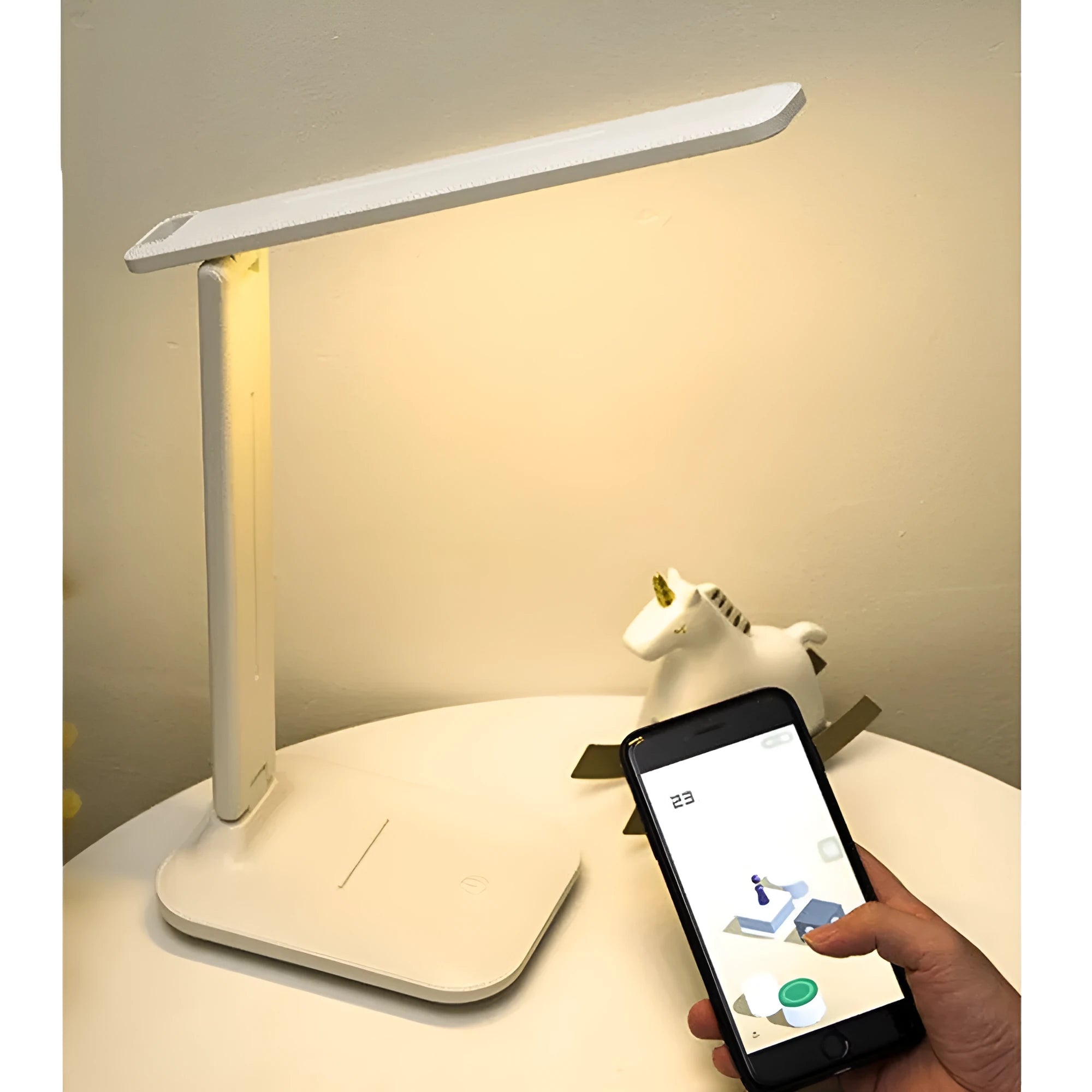 White plastic bedside lamp with touch dimming and colour-changing LED light on a table.
