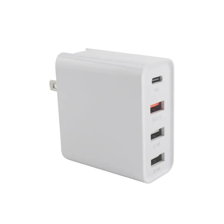 Black 48W desktop charger with four USB-C ports and a white UK plug on a wooden table.