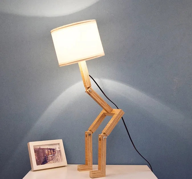 Creative humanoid wooden table lamp with white fabric shade measuring 22x44x16cm