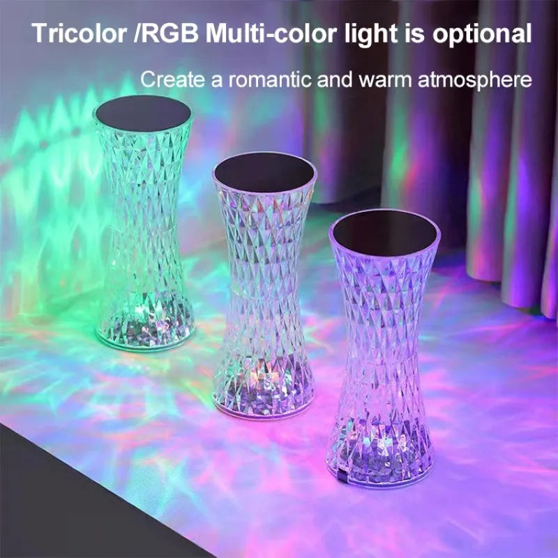 Vase-shaped crystal table lamp with LED lights and remote control on a bedside table