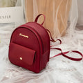 Black PU leather women's shoulder bag also worn as a small backpack, with zipper closure.