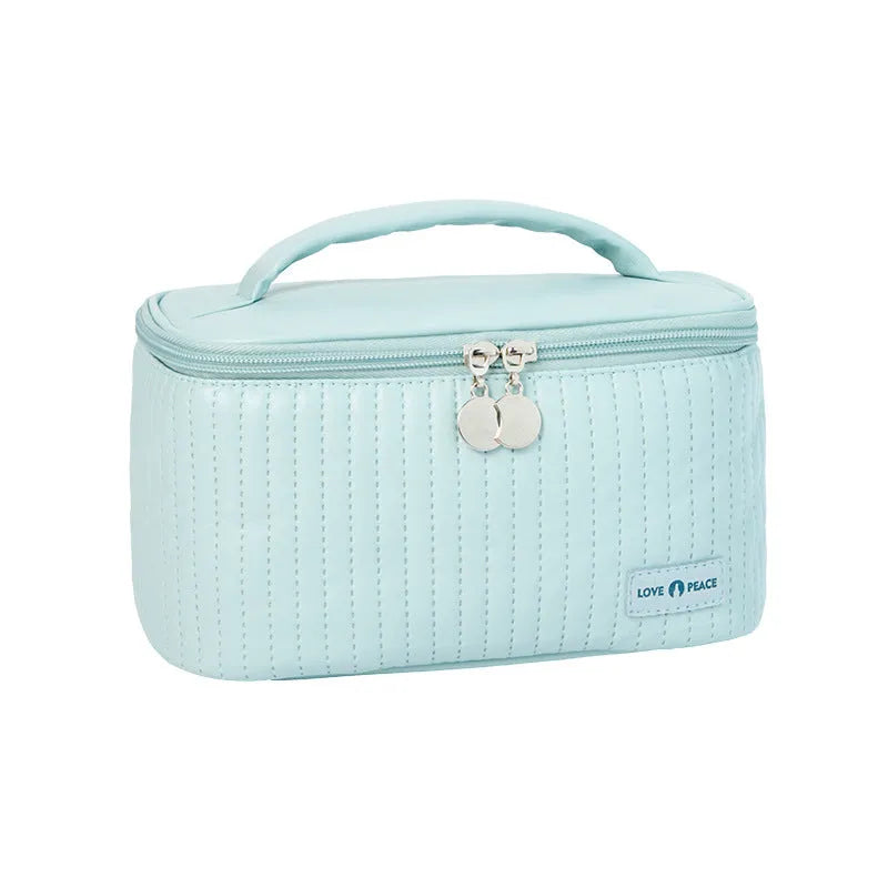 Open-top cake style makeup bag in PU leather showing solid colour options including pink and beige.
