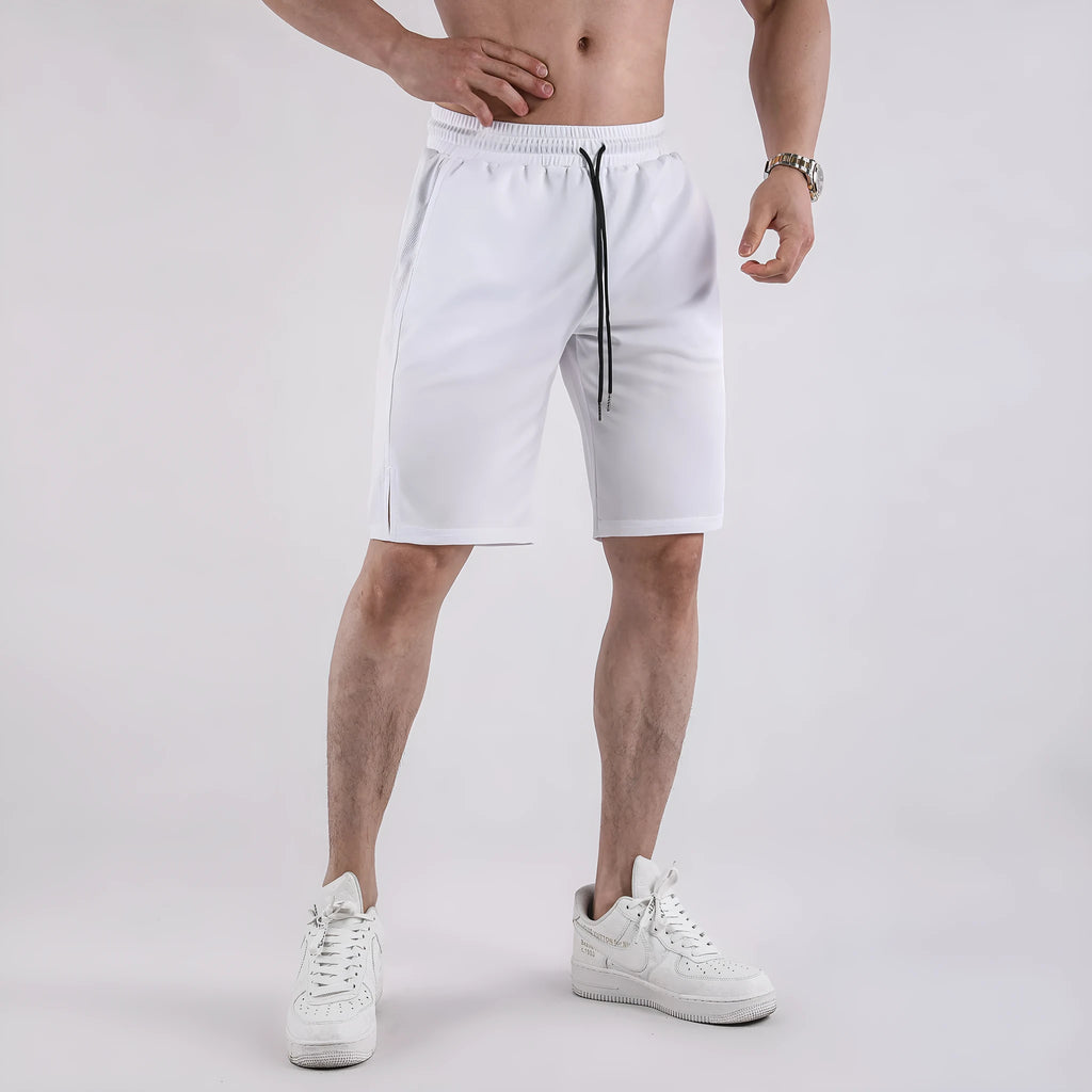 Man wearing black loose-fit quick-dry mesh Capri shorts for summer fitness.