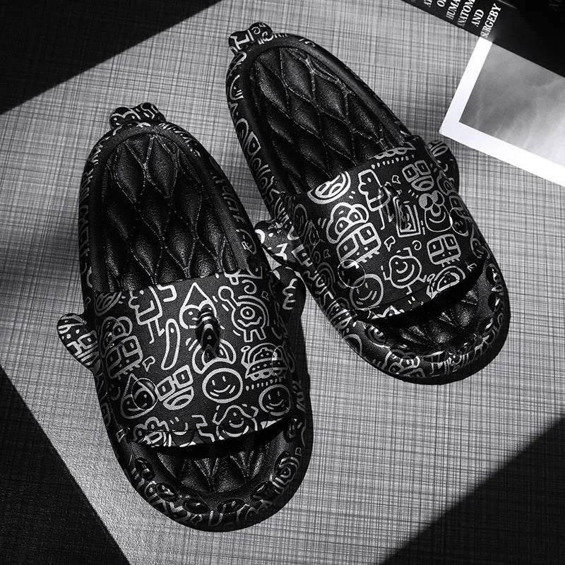 Pair of grey open-toe EVA slippers with raised shark design on the front, shown on a wooden floor.